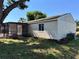 Back exterior view of house featuring a screened in porch at 18459 Inwood Ave, Port Charlotte, FL 33948