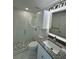 Modern bathroom featuring a glass shower, granite vanity, and built-in cabinet at 18459 Inwood Ave, Port Charlotte, FL 33948