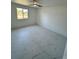 Well-lit bedroom with marble floors, a ceiling fan, and a street view at 18459 Inwood Ave, Port Charlotte, FL 33948