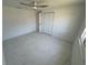 Bedroom featuring marble floors, a ceiling fan, and a large closet at 18459 Inwood Ave, Port Charlotte, FL 33948