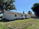 Charming single story home featuring a large tree and well maintained lawn at 18459 Inwood Ave, Port Charlotte, FL 33948