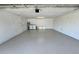 Spacious two car garage with laundry hookups, storage, and a painted floor at 18459 Inwood Ave, Port Charlotte, FL 33948