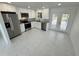 Modern kitchen featuring stainless steel appliances, white cabinets, and a view to the pool at 18459 Inwood Ave, Port Charlotte, FL 33948