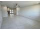 Spacious living room with sleek tile floors, bright lighting, and an open floor plan at 18459 Inwood Ave, Port Charlotte, FL 33948
