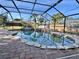 Beautiful screened pool with a unique rock waterfall and spa for relaxation at 18459 Inwood Ave, Port Charlotte, FL 33948