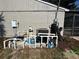View of home's pool equipment and filtration system setup on concrete platform, adjacent to the home's stucco wall at 18459 Inwood Ave, Port Charlotte, FL 33948