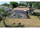 Aerial view of the screen-enclosed in-ground pool and brick surround in the property's backyard at 18459 Inwood Ave, Port Charlotte, FL 33948