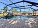 Enjoy the screened pool with rock waterfall and spa with plenty of room for activities at 18459 Inwood Ave, Port Charlotte, FL 33948