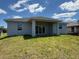 New construction house with covered porch and an open green yard at 198 Arch Dr, Rotonda West, FL 33947