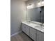 Bright bathroom featuring dual sinks, granite countertops, and a large mirror at 198 Arch Dr, Rotonda West, FL 33947