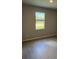 Neutral bedroom with wood-style flooring and natural light at 198 Arch Dr, Rotonda West, FL 33947