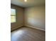 Cozy bedroom with a window, modern flooring, and neutral paint at 198 Arch Dr, Rotonda West, FL 33947