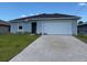 Inviting single-story home with a brick-paved driveway and well-maintained front yard at 198 Arch Dr, Rotonda West, FL 33947