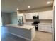 Bright kitchen featuring stainless steel appliances, ample cabinets, and a center island at 198 Arch Dr, Rotonda West, FL 33947