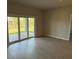 Bright living room with wood-look floors and sliding glass doors to a brick patio at 198 Arch Dr, Rotonda West, FL 33947