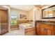 Bright bathroom with a large soaking tub, tile surround, and granite countertops at 2202 Peterborough Rd, Punta Gorda, FL 33983