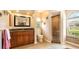 Bathroom with updated vanity, tile floors and glass shower door at 2202 Peterborough Rd, Punta Gorda, FL 33983