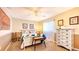 Charming bedroom featuring a stylish dresser, decorative pillows, and natural light at 2202 Peterborough Rd, Punta Gorda, FL 33983