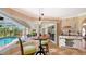 Cozy dining area with views of the pool and lanai, featuring a round table and modern lighting at 2202 Peterborough Rd, Punta Gorda, FL 33983