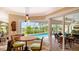 Inviting dining area with large windows overlooking the pool, and sliding door access to the outdoor space at 2202 Peterborough Rd, Punta Gorda, FL 33983