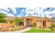 Inviting home entrance with colorful plants, stone bench, and double doors at 2202 Peterborough Rd, Punta Gorda, FL 33983