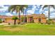 Well-manicured lawn and palm trees create a tropical curb appeal at 2202 Peterborough Rd, Punta Gorda, FL 33983