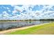 Picturesque lakefront property featuring clear blue sky and inviting community atmosphere at 2202 Peterborough Rd, Punta Gorda, FL 33983
