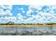 Stunning lake view with bright blue sky, reflecting the beauty of the surrounding homes at 2202 Peterborough Rd, Punta Gorda, FL 33983
