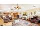 Comfortable living room featuring an open layout connecting to the kitchen, and a decorative ceiling fan at 2202 Peterborough Rd, Punta Gorda, FL 33983