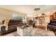 Open-concept living room showcasing wood floors, plush furniture, and access to the kitchen at 2202 Peterborough Rd, Punta Gorda, FL 33983