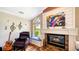 Living room with decorative fireplace, musical decor and view of backyard water feature at 2202 Peterborough Rd, Punta Gorda, FL 33983