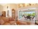 Cozy living room with vaulted ceiling, hardwood floors, and sliding glass doors to the outdoor pool area at 2202 Peterborough Rd, Punta Gorda, FL 33983