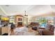 Bright living room with fireplace, large windows, comfortable seating, and view of the pool at 2202 Peterborough Rd, Punta Gorda, FL 33983