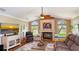 Cozy living room featuring a fireplace, water view, entertainment center and comfortable seating at 2202 Peterborough Rd, Punta Gorda, FL 33983