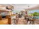 Open-concept living space with kitchen island, dining area, a living room, and a view of the pool at 2202 Peterborough Rd, Punta Gorda, FL 33983