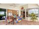 Enclosed patio featuring colorful outdoor seating and a brick-paved floor, perfect for relaxing and entertaining at 2202 Peterborough Rd, Punta Gorda, FL 33983