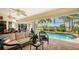 Inviting outdoor pool with patio furniture, lush landscaping, and serene views at 2202 Peterborough Rd, Punta Gorda, FL 33983