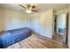 Cozy bedroom featuring hardwood floors, a ceiling fan, and a closet for storage at 2314 Lee Ter, Port Charlotte, FL 33952