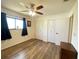 Well-lit bedroom featuring hardwood floors, a ceiling fan, and a double closet with doors at 2314 Lee Ter, Port Charlotte, FL 33952