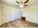 Bright bedroom with light hardwood floors, a ceiling fan, and a closet for storage at 2314 Lee Ter, Port Charlotte, FL 33952