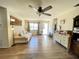 Spacious living room with light hardwood floors, a ceiling fan, and ample natural light at 2314 Lee Ter, Port Charlotte, FL 33952