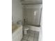Clean bathroom with a shower and tub combo, white cabinets and ceramic tile flooring at 25050 Sandhill Blvd # B3, Punta Gorda, FL 33983