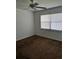 Cozy bedroom with a ceiling fan, large window, and neutral carpet at 25050 Sandhill Blvd # B3, Punta Gorda, FL 33983