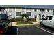Condo building with lush landscaping, open stairwells and updated exterior paint at 25050 Sandhill Blvd # B3, Punta Gorda, FL 33983