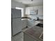 Well lit kitchen with tile countertops, white appliances and white cabinets at 25050 Sandhill Blvd # B3, Punta Gorda, FL 33983