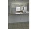 Compact kitchen with essential appliances, white cabinetry, and functional countertop space at 25050 Sandhill Blvd # B3, Punta Gorda, FL 33983
