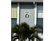 The Pines condo sign with a palm tree in the foreground on a sunny day at 25050 Sandhill Blvd # B3, Punta Gorda, FL 33983