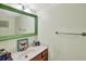 Charming bathroom with a decorative mirror, wooden vanity, and ample counter space at 25188 Marion Ave # 1038, Punta Gorda, FL 33950