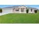 Charming single-story home featuring a well-manicured lawn and attached two-car garage at 2531 Pebble Creek Pl, Port Charlotte, FL 33948