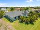 Aerial view of a home showcasing a screened pool and tropical landscaping at 265 White Marsh Ln, Rotonda West, FL 33947
